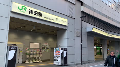 Panoramic-of-Kanda-Station-South-gate-with-people,-lockers,-and-vending-machine