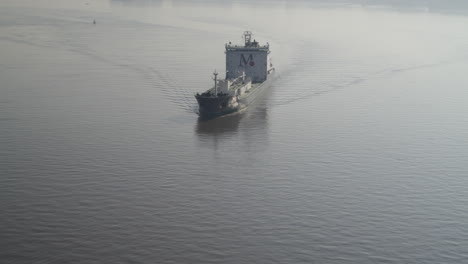 Aerial-view-of-a-cargo-ship-on-the-River-Thames,-Kent---Essex-England