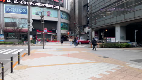 Panoramic-around-the-Central-gate-of-Akihabara-Station-with-people,-shops-and-vehicles