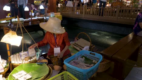 Colourful-close-up-panning-shot-across-traditional-old-style-floating-market-inside-luxury-Icon-Siam-shopping-mall,-Bangkok,-Thailand