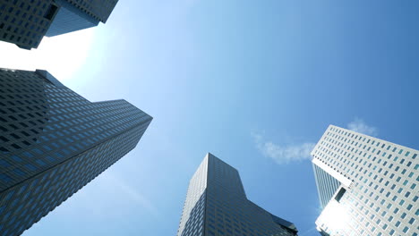 Singapore-Urban-Skyscraper-Towers-Timelapse-With-Blue-Sky-and-Clouds