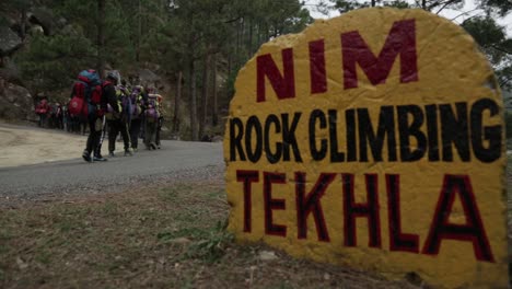 NIM-Trainees-on-their-way-to-trail,-passing-through-road-sign-of-NIM