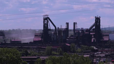 Factories-producing-pollution-in-the-air-on-a-sunny-day-with-blue-skies