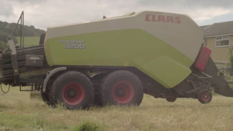 Reversing-tractor-in-hay-fields-pulling-a-baler