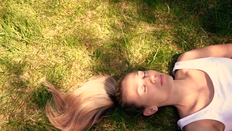 Girl's-feet-walking-through-grass-in-slow-motion