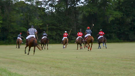 group-of-polo-players-on-horses-chasing-ball