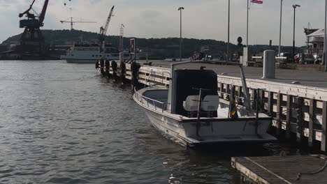 View-over-a-swedish-boat-laying-docked-to-the-harbour-located-in-Gota-Alv-in-Gothenburg,-Sweden