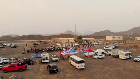 Filipino-mountain-bikers-at-the-starting-line-of-a-cycling-race-event-in-a-barren-area-with-mountains---AERIAL-SHOT