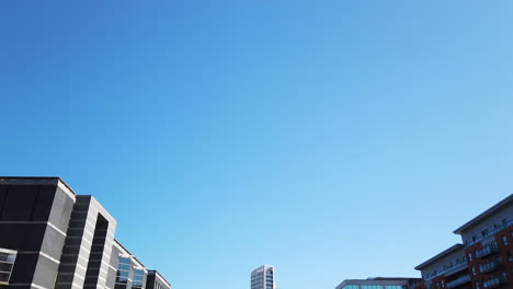 Shot-of-Leeds-Dock-Mixed-Development-in-Yorkshire,-UK-on-a-Sunny-Summer’s-Day-Fading-Out-Upwards-to-Blue-Sky