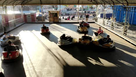 children-and-teenagers-playing-in-electric-bumper-cars-in-theme-amusement-park-on-a-sunny-day-in-montevideo-uruguay-4K-video