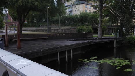 Wide-Shot-of-a-Bridge-by-The-Stream-Viskan-in-Borås-Sweden-on-a-Grey-Cloudy-Day-Near-The-University