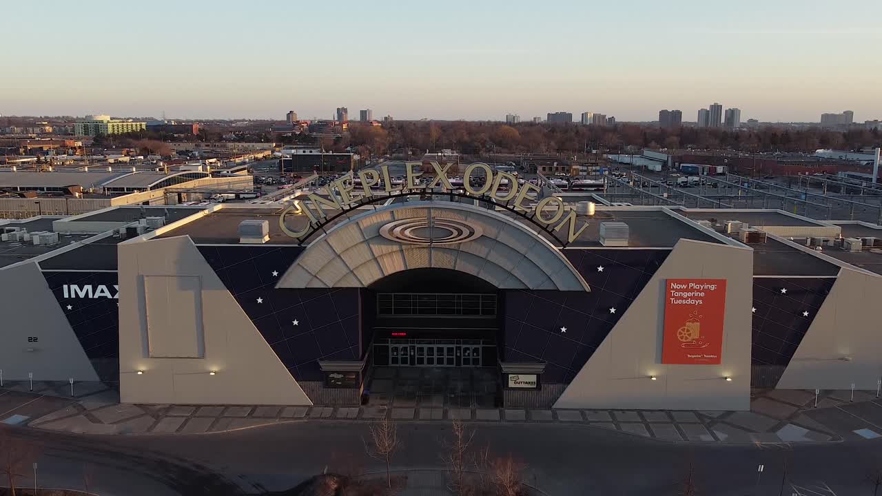 Flyover Of Cineplex Odeon Movie Theatre Cinema Exterior With Signage ...