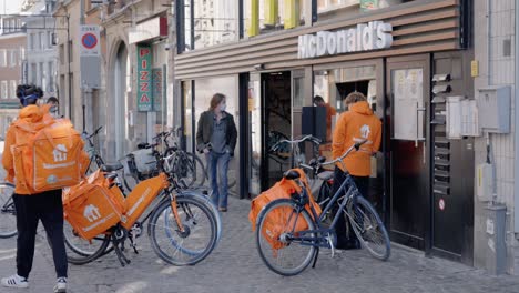 Delivery-drivers-waiting-outside-a-McDonald's-restaurant-in-Leuven,-Belgium