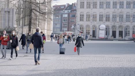 People-with-protective-face-masks-walk-at-the-Grand-Square-in-Leuven,-Covid-19-corona-virus-in-Belgium