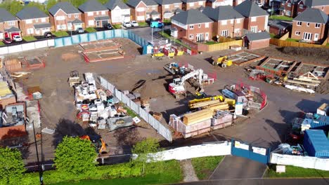 Construction-site-aerial-view-above-new-urban-real-estate-housing-development-regeneration-zoom-in-birdseye