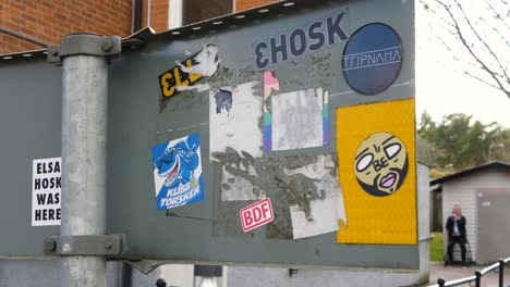 Closeup-Of-Social-And-Promotional-Stickers-On-The-Back-Of-A-Street-Sign-In-Gothenburg,-Sweden