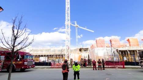 Bomberos-Parados-Fuera-De-Un-Sitio-De-Construcción---Tiro-Giratorio