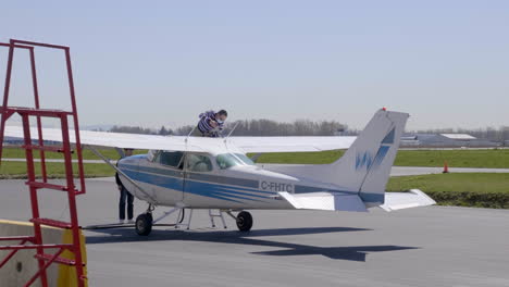 Crew-Wearing-Face-Mask-Refueling-Light-Aircraft-Of-Cessna-172-Plane