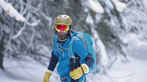 Athletic-man-smiling-into-camera-while-preparing-for-skiing