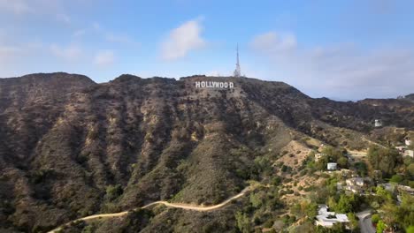 Famous-Hollywood-sign,-aerial-view-towards-mountain-over-homes,-cloudy-day