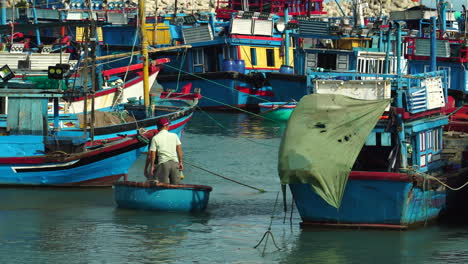 Zwei-Fischer-Steuern-Ein-Coracle-Boot-Zwischen-Fischereifahrzeugen-Im-Hafen-Von-Vinh-Hy