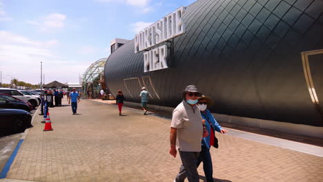 People-Walking-At-The-Front-Yard-Of-Portside-Pier-Restaurant-On-Sunny-Day-In-San-Diego,-California