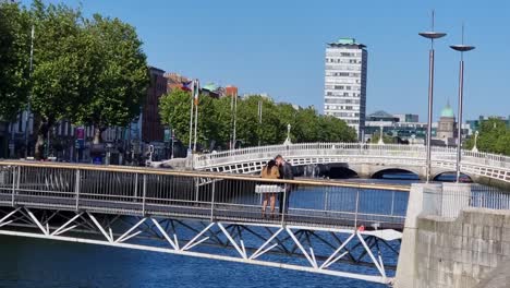 Panning-shot-moving-to-the-right-in-the-heart-of-temple-bar-of-people-out-in-a-sunny-afternoon-eating-and-drinking-in-Ireland-with-outdoor-dining