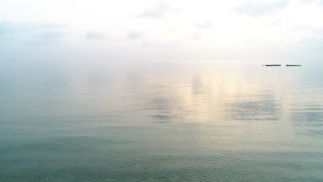 Beach-top-view-or-aerial-view-showing-white-wave-foam-hit-the-sand-beach-with-turquoise-water