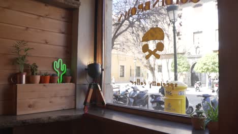 POV-of-A-Person-Looking-Outside-From-Glass-Window-Of-Coffee-Shop