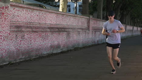 Morning-Joggers-Running-Past-The-National-Covid-Memorial-Wall-At-North-Wing-Lambeth-Palace-Road