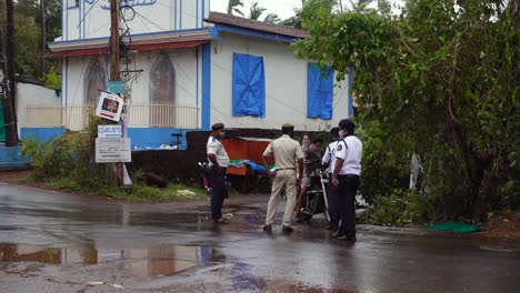 Several-Indian-Police-Officers-Stop-Motorcycle-in-Traffic-Stop-on-Rainy-Day