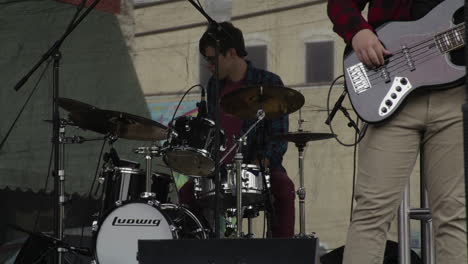 Drummer-at-concert-at-Dogwood-Festival,-Siloam-Springs,-AR,-slow-motion-wide-shot