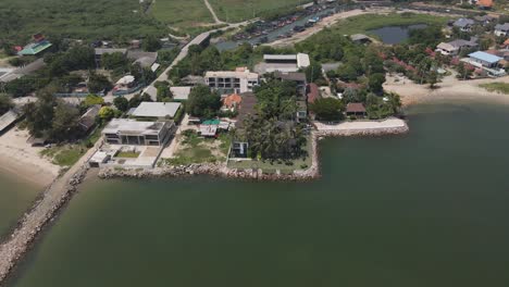 4K-Aerial-Drone-Footage-Orbital-Shot-of-Hotel-Property-Along-the-Beach-of-Ban-Laem-in-Phetchaburi,-Thailand