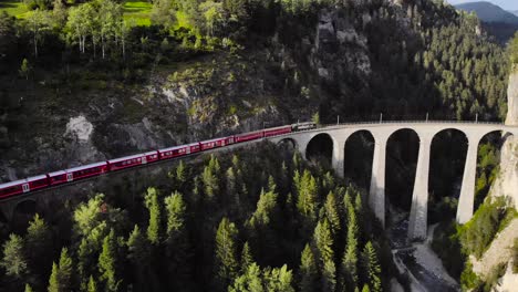 Aerial:-red-train-on-the-Landwasser-viaduct