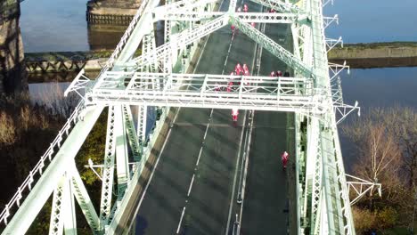 Charity-Santa-dash-fun-run-over-Runcorn-Silver-Jubilee-bridge-Aerial-view-closeup-birdseye-tilt-down