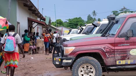 Daily-scene-of-people-and-public-transportation-trucks-at-Kokopau-boat-crossing-on-Buka-Passage-on-the-tropical-island-of-Autonomous-Region-of-Bougainville,-Papua-New-Guinea