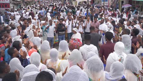 A-drum-player-in-the-middle-of-many-people-who-is-singing-and-swinging-to-his-rhythm-celebrating-the-tabot-day-in-Ethiopia-2022