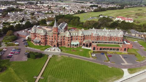 Aerial-view-of-Slieve-Donard-Resort-and-Spa-in-Newcastle-on-a-sunny-day,-County-Down,-Northern-Ireland