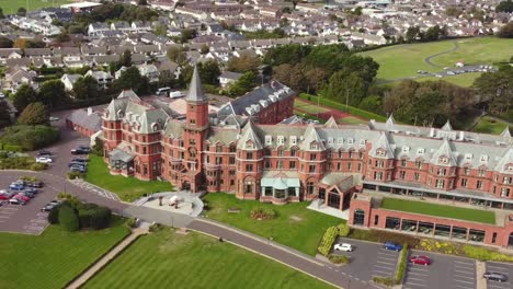 Aerial-view-of-Slieve-Donard-Resort-and-Spa-in-Newcastle-on-a-sunny-day,-County-Down,-Northern-Ireland