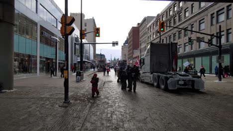 A-crowd-of-people-walking-in-front-of-the-freedom-convoy