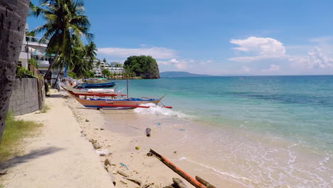 Walking-Peacefully-On-A-Beautiful-White-Sand-Beach-During-A-Sunny-Day-In-Puerto-Galera-Philippines