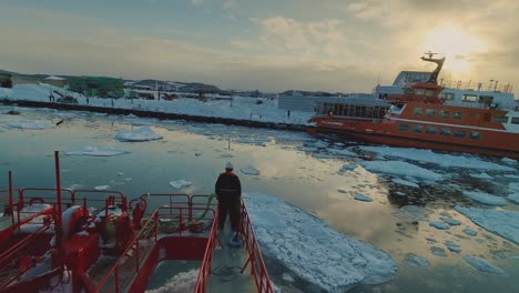 Garinko-II-Drift-Ice-Cruise-Ship-Coming-Into-Dock-At-Pier-In-Monbetsu-With-Mariner-On-Forward-Bow-Looking-Out