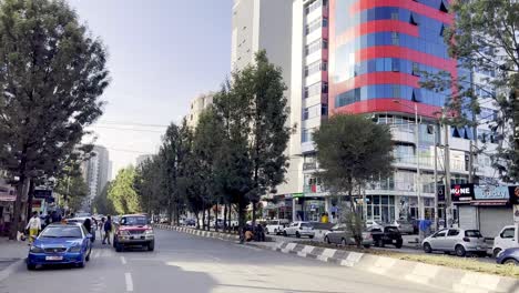 cars-on-roadway-in-addis-ababa-ethiopia,-modern-street-scene-with-skyscrapers-in-ethiopia