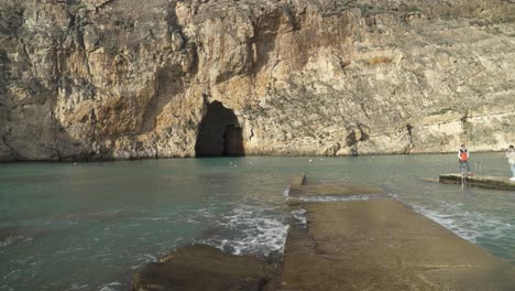 Young-Couple-Taking-Pictures-near-Inland-Sea-Caves-Area-in-Malta-on-Gozo-Island