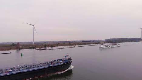 Aerial-Dolly-Across-Tanker-Ship-With-River-Princess-Cruise-Ship-Approaching-On-Cloudy-Day-On-Oude-Maas