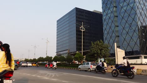 View-of-the-vehicles-moving-on-the-high-way-road-in-front-of-the-high-office-buildings-on-a-summer-day-in-Hyderabad