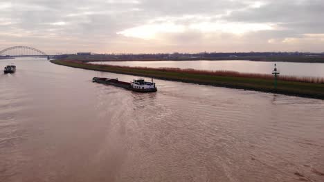 Aerial-Over-Stedo-Inland-Freighter-Heading-Towards-Alblasserdamsebrug-In-Ridderkerk-Beside-Crezeepolder-Nature-Reserve