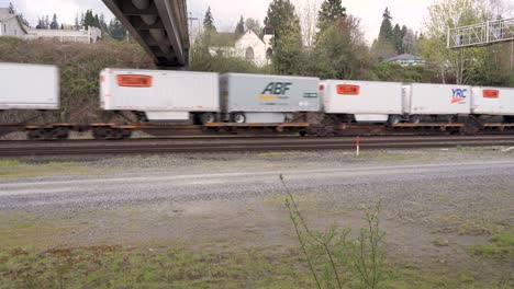 Zug-Von-Tiefladern-Mit-LKW-Containern-Fährt-Unter-Der-Unterführung-Hindurch