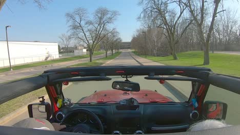 POV-while-a-white-haired-couple-are-driving-around-the-roads-of-Moline-Senior-High-School-campus-in-early-spring