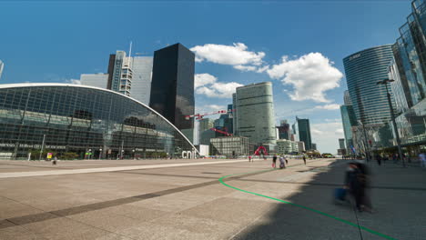 Parvis-De-La-Plaza-De-La-Defensa-Con-Edificio-Cnit-Y-Gente-Caminando-Durante-El-Lapso-De-Tiempo-De-Gran-Angular-De-Día-Soleado